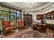 Spacious home office features built-in bookshelves and a large desk, perfect for working from home at 9719 E Madera Dr, Scottsdale, AZ 85262