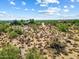 Aerial view of vacant land with distant views of homes and mountains at 0 E Red Bird Rd, Scottsdale, AZ 85262