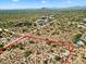 Aerial view of vacant land with red boundary lines and a neighboring house at 0 E Red Bird Rd, Scottsdale, AZ 85262