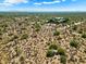 Aerial view of vacant land in a desert setting with distant mountain views at 0 E Red Bird Rd, Scottsdale, AZ 85262