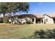 Back exterior of home with private patio and lawn at 23817 S Harmony Way, Sun Lakes, AZ 85248