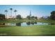 Picturesque golf course with calm lake and residential homes at 23817 S Harmony Way, Sun Lakes, AZ 85248