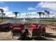 Outdoor patio with red seating, overlooking a lake with fountain at 23817 S Harmony Way, Sun Lakes, AZ 85248