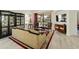 Living area with ornate furniture, a large TV, and access to the backyard at 23817 S Harmony Way, Sun Lakes, AZ 85248