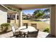 Private patio with a table and chairs, overlooking a lush lawn at 23817 S Harmony Way, Sun Lakes, AZ 85248