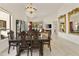 Formal dining room with chandelier and a view into the living room at 23817 S Harmony Way, Sun Lakes, AZ 85248