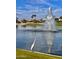 Tranquil lake view with fountain and a majestic bird at 23817 S Harmony Way, Sun Lakes, AZ 85248