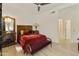 Elegant bedroom with antique furniture and a red velvet bedspread at 23817 S Harmony Way, Sun Lakes, AZ 85248