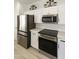 Stainless steel appliances and white shaker cabinets highlight this kitchen at 23817 S Harmony Way, Sun Lakes, AZ 85248