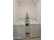 Bright laundry room with washer, dryer, and storage shelving at 23817 S Harmony Way, Sun Lakes, AZ 85248
