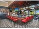 Restaurant bar with a large counter and red barstools at 23817 S Harmony Way, Sun Lakes, AZ 85248