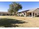 Back exterior view of property showcasing a manicured lawn at 23817 S Harmony Way, Sun Lakes, AZ 85248