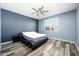 Spacious bedroom with ceiling fan and grey wood-look flooring at 12568 W Orangewood Ave, Glendale, AZ 85307