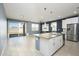 Spacious kitchen with large island, stainless steel appliances, and access to backyard at 12568 W Orangewood Ave, Glendale, AZ 85307