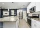 Modern kitchen with white cabinets and granite countertops at 12568 W Orangewood Ave, Glendale, AZ 85307