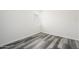 Small bedroom with grey wood-look flooring and a window at 12568 W Orangewood Ave, Glendale, AZ 85307