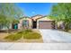 Modern single-story home with brown garage door at 12568 W Orangewood Ave, Glendale, AZ 85307