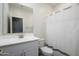 Clean bathroom with white vanity, shower/tub combo, and white tile flooring at 12568 W Orangewood Ave, Glendale, AZ 85307