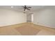 Spacious living room featuring tile floors and a ceiling fan at 10650 N 49Th Ave, Glendale, AZ 85304