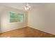 Bright bedroom with wood-look floors and ceiling fan at 10650 N 49Th Ave, Glendale, AZ 85304