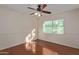 Bedroom with wood flooring and large window at 10650 N 49Th Ave, Glendale, AZ 85304