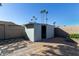 Exterior view of a light blue storage shed in the backyard at 10650 N 49Th Ave, Glendale, AZ 85304
