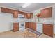 Kitchen with brown cabinets and white appliances at 10650 N 49Th Ave, Glendale, AZ 85304