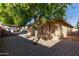 Back exterior view of the house with brick pavers and landscaping at 10650 N 49Th Ave, Glendale, AZ 85304