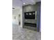 Modern fireplace with a large TV and LED lighting at 20216 W Desert Bloom St, Buckeye, AZ 85326