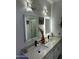 Double vanity bathroom with LED lit mirrors at 20216 W Desert Bloom St, Buckeye, AZ 85326