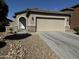A charming one-story house with a two-car garage and rock landscaping at 20216 W Desert Bloom St, Buckeye, AZ 85326