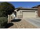 One-story home with tan exterior, two-car garage, and desert landscaping at 20216 W Desert Bloom St, Buckeye, AZ 85326