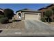 Front view of a one-story house with a two-car garage and landscaping at 20216 W Desert Bloom St, Buckeye, AZ 85326