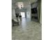 Open living area with a modern fireplace, large TV, and tile floors at 20216 W Desert Bloom St, Buckeye, AZ 85326