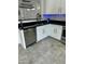 Modern kitchen with white cabinets, stainless steel dishwasher and granite countertops at 20216 W Desert Bloom St, Buckeye, AZ 85326