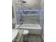 Bathroom with bathtub and marble tile at 20216 W Desert Bloom St, Buckeye, AZ 85326