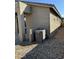 Rear exterior view of the home showcasing the AC unit and rock landscaping at 20216 W Desert Bloom St, Buckeye, AZ 85326
