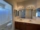 Bathroom with double sinks, large mirror, and tub shower combo at 2667 S 156Th Ave, Goodyear, AZ 85338