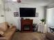 Living room showcasing a fireplace and mounted TV at 6232 E Decatur St, Mesa, AZ 85205