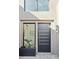 Contemporary entry with sleek door and large window, modern planter at 37200 N Cave Creek Rd # 1055, Scottsdale, AZ 85262