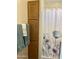 Clean bathroom with a shower/tub, linen closet, and floral shower curtain at 7750 E Broadway Rd # 761, Mesa, AZ 85208