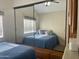 Main bedroom with mirrored closet doors and a comfortable bed at 7750 E Broadway Rd # 761, Mesa, AZ 85208