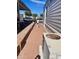 Brick walkway alongside mobile home, leading to AC unit at 7750 E Broadway Rd # 761, Mesa, AZ 85208
