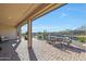 Spacious covered patio overlooking a serene pond with seating area at 16866 S 180Th Ave, Goodyear, AZ 85338