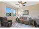 Relaxing living room featuring a sofa and recliner, offering backyard views at 16866 S 180Th Ave, Goodyear, AZ 85338