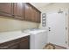 Bright laundry room with washer, dryer, and ample cabinetry at 16866 S 180Th Ave, Goodyear, AZ 85338