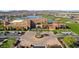 Aerial view of the community clubhouse, lake, and surrounding homes at 16866 S 180Th Ave, Goodyear, AZ 85338