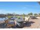 Relaxing patio with fire pit and seating area near a tranquil pond at 16866 S 180Th Ave, Goodyear, AZ 85338
