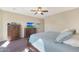 Comfortable bedroom with wood furniture and large windows at 16866 S 180Th Ave, Goodyear, AZ 85338