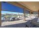 Relaxing covered patio with seating area overlooking a pond at 16866 S 180Th Ave, Goodyear, AZ 85338